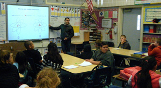 Cristian teaching chemistry to a class of elementary students