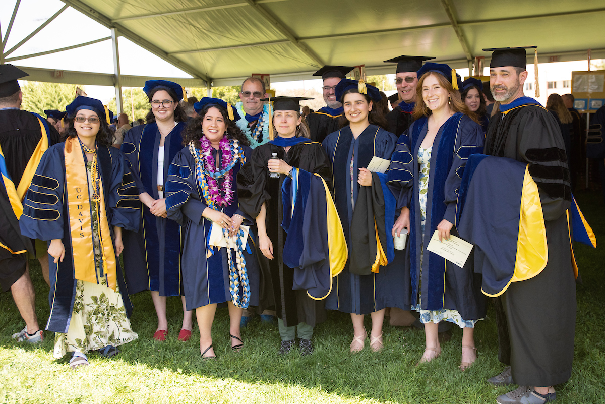 Group of MFA and Doctoral graduates smiling.