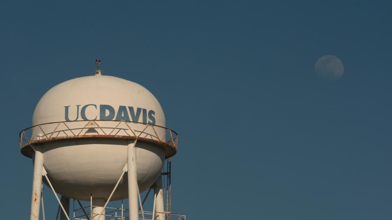 The gibbous moon rises over Water Tower on March 26, 2021.