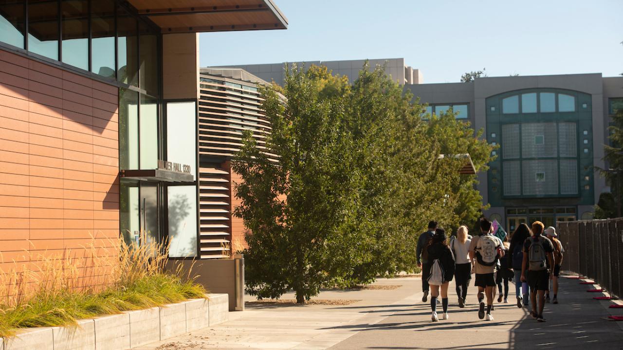 Students do a Orientation Tour with a tour leader and walk by Walker Hall.