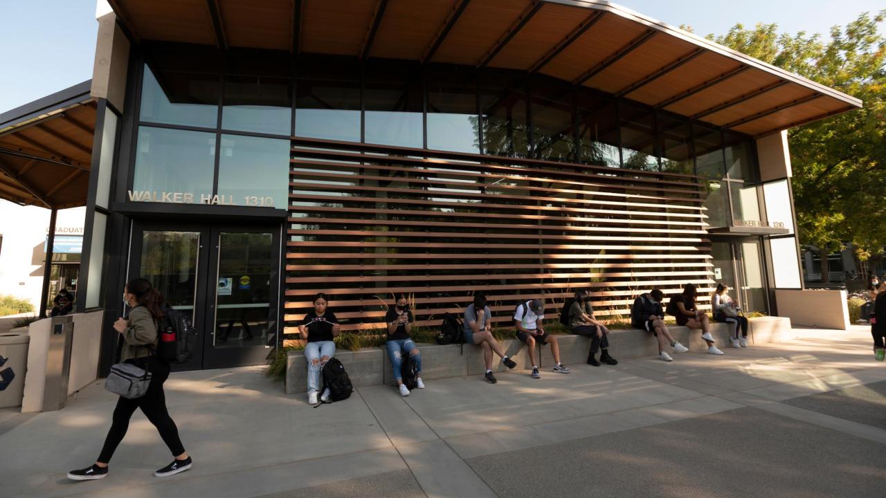 Students Sit on the promenade in Walker Hall 