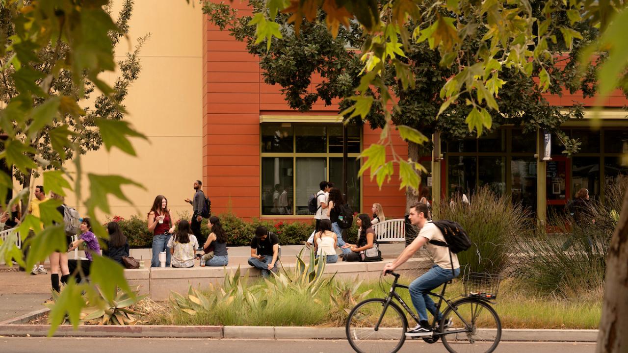 Students talks outside the Student Community Center on the first day of class.