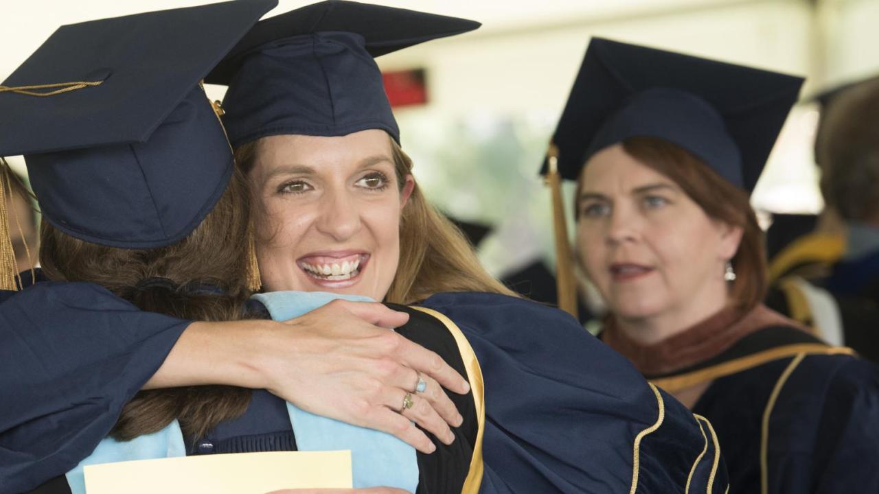 A hug is shared at UC Davis Graduate Studies Commencement.