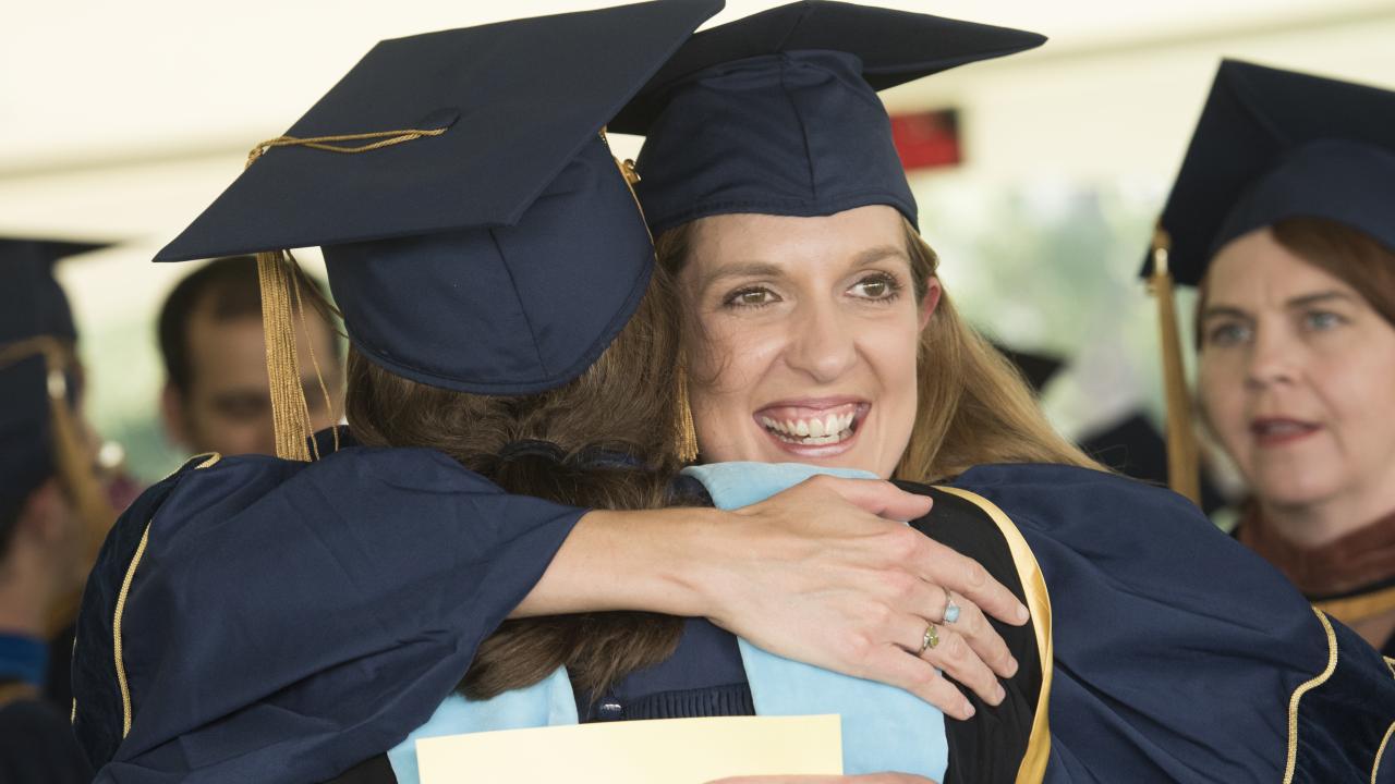 A hug is shared at UC Davis Graduate Studies Commencement.