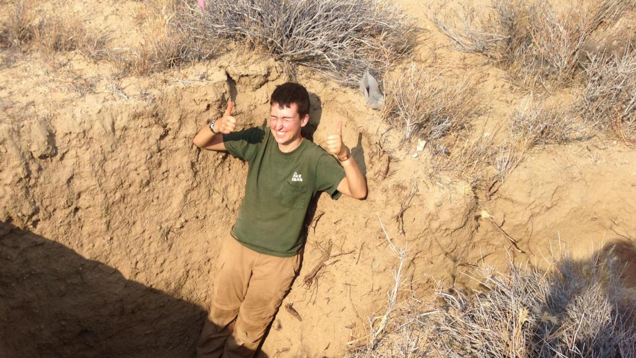 UC Davis graduate student Emery Anderson-Merritt in a hole in the ground