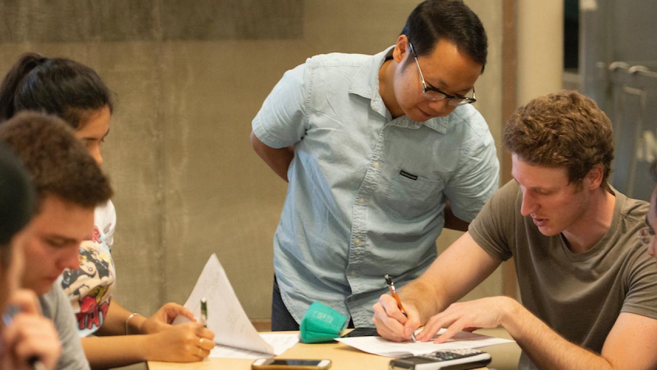 Chang Vang, graduate student aerospace engineering and teaching assistant, instructs Brandon Conroy, a mechanical engineering major, on what methods they need to use for their data during the engineering class of Exerimental Methods for Thermal 