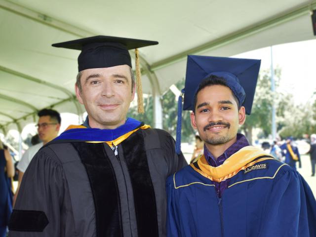 faculty member and student in academic regalia at commencement