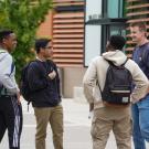 Students talking on the pathway near Walker Hall and Sheilds Library.