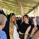Parent taking photo of graduate.