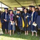 Group of MFA and Doctoral graduates smiling.
