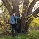 Pictured, Groh with a California black walnut tree on the UC Davis campus.