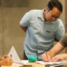 Chang Vang, graduate student aerospace engineering and teaching assistant, instructs Brandon Conroy, a mechanical engineering major, on what methods they need to use for their data during the engineering class of Exerimental Methods for Thermal 
