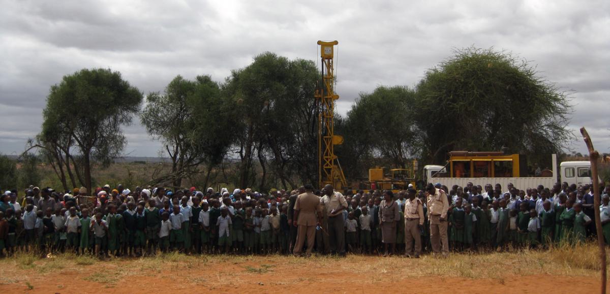 group of children in front of drilling rig in Kenya